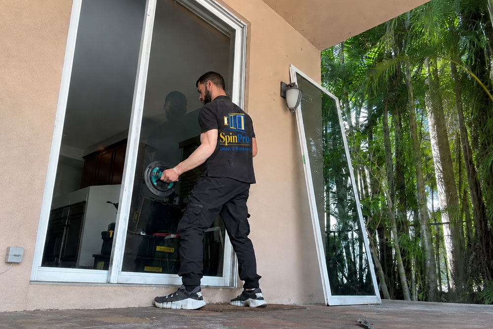 SpinPro technician removing a sliding glass door for repair